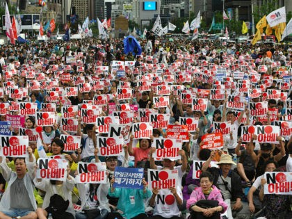 TOPSHOT - South Korean protesters hold signs reading "No Abe!" during an anti-Japanese rally marking the anniversary of Korea's liberation from Japan's 1910-45 colonial rule, in central Seoul on August 15, 2019. - South Korean President Moon Jae-in struck a conciliatory tone towards Japan on August 15, offering to "join …