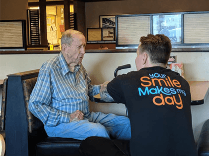 A sweet story behind images of an elderly man and his waiter is being shared by thousands on Facebook.