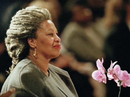 FILE - In this April 5, 1994 file photo, Toni Morrison as she holds an orchid at the Cathe