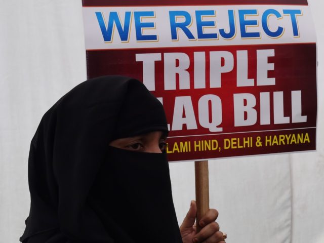 An Indian Muslim woman holds a placard during a protest against the "triple talaq bill" in New Delhi on April 4, 2018. Muslim women in India have gathered to protest the "Muslim Women (Protection of Rights on Marriage) Bill 2017" that makes triple talaq illegal. Instant divorce or "triple talaq" …