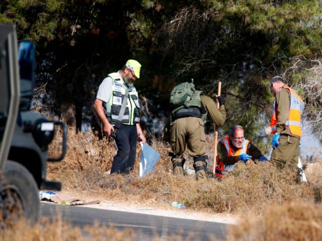 Israeli soldiers and forensic experts inspect the scene where the body of an Israeli soldi
