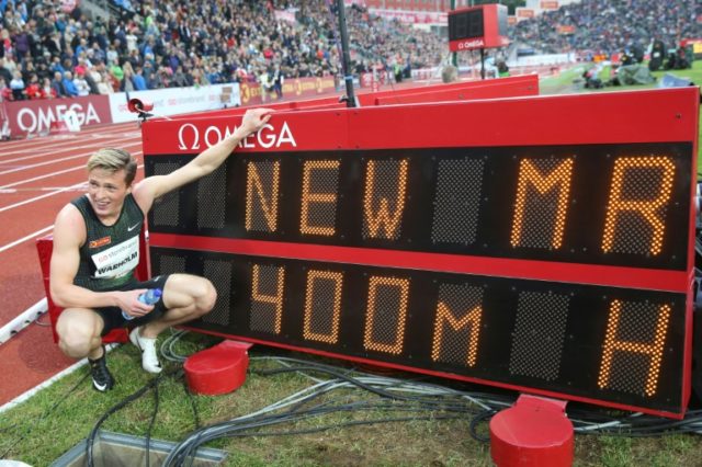 Warholm races to break hurdles world record
