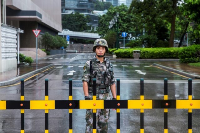 China rotates troops in Hong Kong as police ban new rally