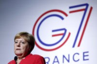 The Latest: Merkel says worth seizing chance to talk to Iran