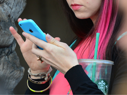 Women use their cellphones on January 7, 2014 in Los Angeles, California. Former NSA contr
