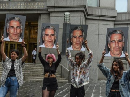 women holding pictures of Jeffrey Epstein