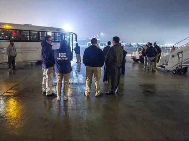 ICE ERO officers prepare to board a group of migrants on a charter removal flight. (File P