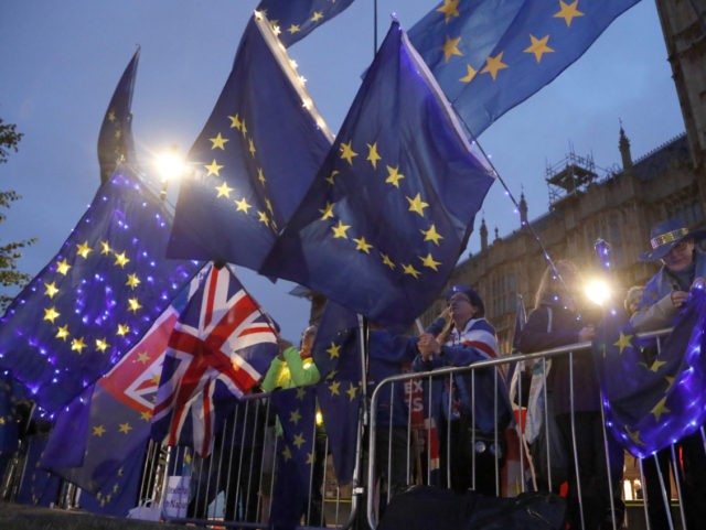 Pro EU protestors wave flags opposite parliament in London, Monday, Sept. 9, 2019. British