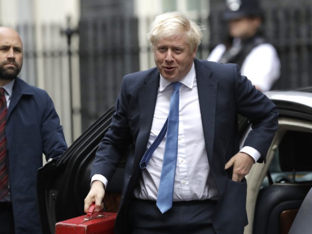 British Prime Minister Boris Johnson, center, arrives at Downing Street in London, Wednesd