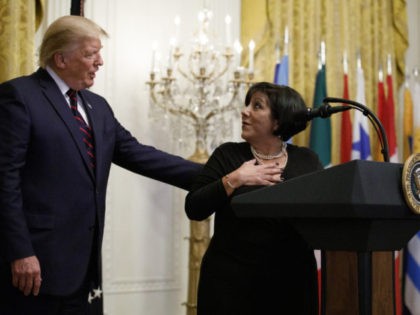 President Donald Trump talks with Martha Avila of Heartbeat of Miami Pregnancy Help Medical Clinics on stage during the Hispanic Heritage Month Reception in the East Room of the White House in Washington, Friday, Sept. 27, 2019. (AP Photo/Carolyn Kaster)