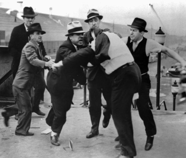 FILE - In this May 26, 1937 file photo, Richard Frankensteen, United Auto Workers organizational director, with coat pulled over his head, is pummeled by Ford Motor. Co. agents at the gate of the Ford River Rouge Complex in Dearborn, Mich. Ford security personnel were countering the UAWs efforts to organize employees at the factory complex. The union marks the 75th anniversary of the event known as the Battle of the Overpass on Friday, May 25, 2012, with a ceremony at the site. (AP Photo, File)