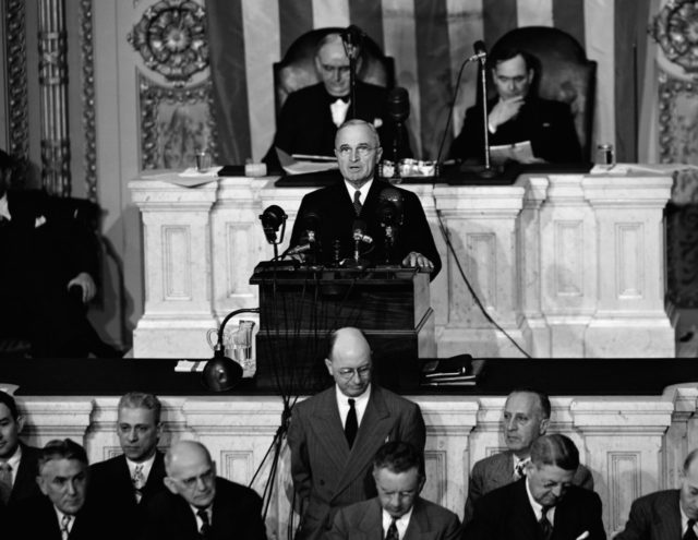 President Harry S. Truman delivers his State of the Nation address before a joint session of Congress in the House Of Representatives Chamber in Wash., D. C., January 6, 1947. President Truman asked fro mild curbs on labor and urged congress to keep luxury taxes. Seated behind him are Senate president pro tempore Arthur H. Vandenberg (R-Michigan) and Speaker of the House Joseph W. Martin, Jr. (AP Photo)