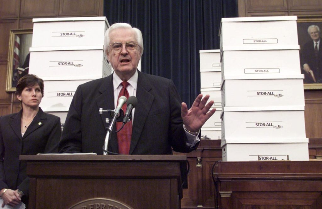 Surrounded by boxes of evidence against President Clinton, House Judiciary Committee Chairman Rep. Henry Hyde, R-Ill., accompanied by committee member Rep. Mary Bono, R-Calif., gestures during a Capitol Hill news conference to say that the committee has "made a compelling case" for impeachment against the President. Starting Tuesday, the president's attorneys will present a defense before the committee. (AP Photo/Joe Marquette)