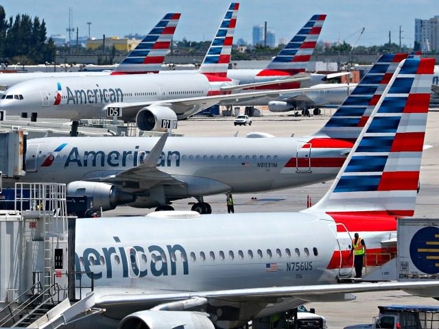 In this April 24, 2019, photo, American Airlines aircraft are shown parked at their gates at Miami International Airport in Miami. An American Airlines mechanic is accused of sabotaging a flight from Miami International Airport to Nassau in the Bahamas, over stalled union contract negotiations. Citing a criminal complaint affidavit …