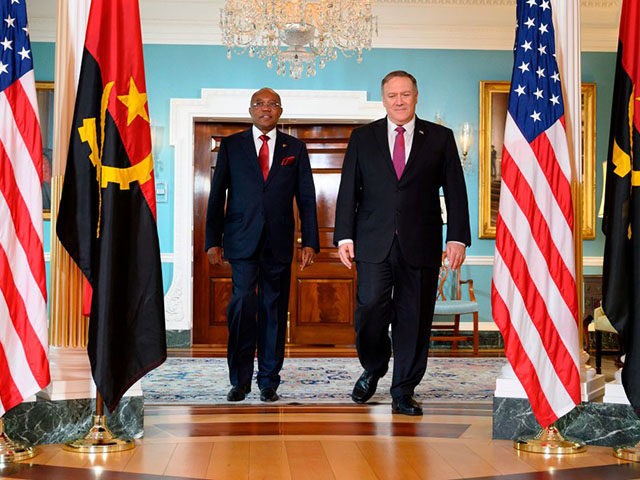 Angolan Foreign Minister Manuel Domingos Augusto (L) walks with US Secretary of State Mike