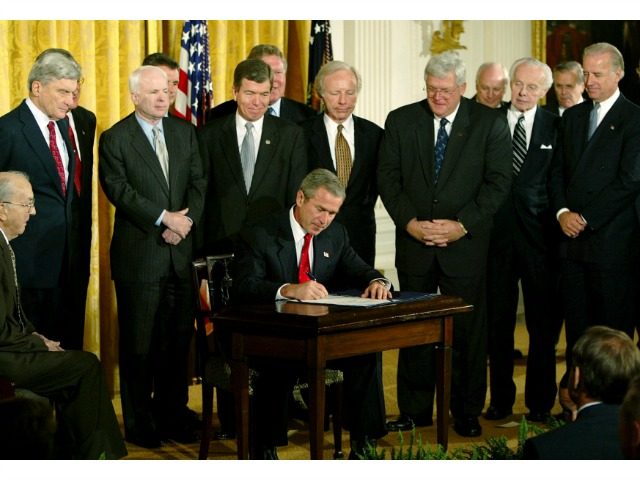 President Bush signs a resolution authorizing the use of force against Iraq, Wednesday, Oc