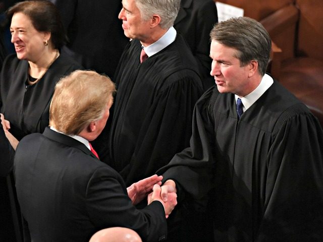 US President Donald Trump shakes hands with US Supreme Court Justice Brett Kavanaugh befor
