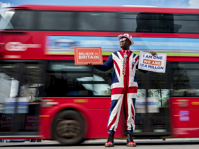 A pro-Brexit campaigner wears the Union flag colours and holds placards as he demonstrates near the Houses of Parliament in central London on April 3, 2019. - Prime Minister Theresa May was to meet on Wednesday with the leader of Britain's main opposition party in a bid to thrash out …