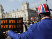 Pro-Brexit activist Joseph Afrane holds a placard as he demonstrates outside the Houses of Parliament in Westminster, London on March 28, 2019. - Faced with losing all control over the Brexit process, British Prime Minister Theresa May looks to have played her final card by announcing she will step down &hellip;