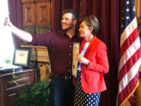 Carson King, of Altoona, Iowa, snaps a selfie Wednesday, Sept. 25, 2019, in the Iowa State Capitol in Des Moines, Iowa, with Iowa Gov. Kim Reynolds, who holds a proclamation declaring Saturday as Carson King Day. The honor was to mark King’s plans to donate more than $1 million to …