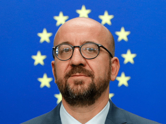 TOPSHOT - Belgium's Prime Minister Charles Michel looks on as he addresses the media after
