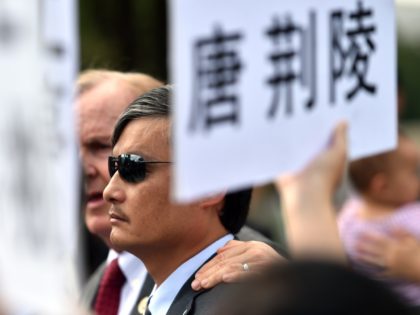 Blind Chinese activist Chen Guangcheng (C) together with relatives of political prisoners held in China takes part in a protest outside the Capitol in Washington DC on September 17, 2014. The daughters and relatives of political prisoners held in China made an appeal to Beijing to let their fathers and …