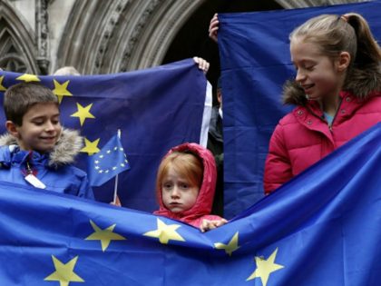 Pro-European Union (EU) supporter stands at the entrance to The Royal Courts of Justice, Britain's High Court, in London on October 13, 2016, during a protest against the UK's decision to leave the EU. The battle over Britain's exit from the European Union (Brexit) reached the High Court on Thursday …
