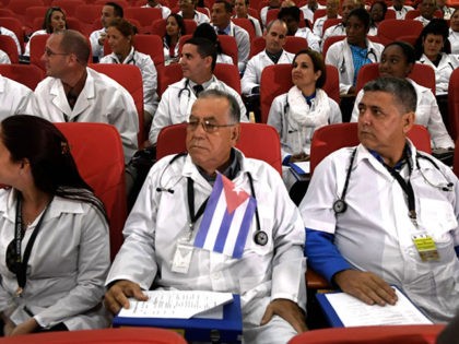 Some 100 Cuban doctors follow proceedings during their induction programme at the Kenya Sc