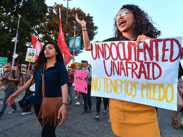 Young immigrants, activists and supporters of the DACA program march through downtown Los