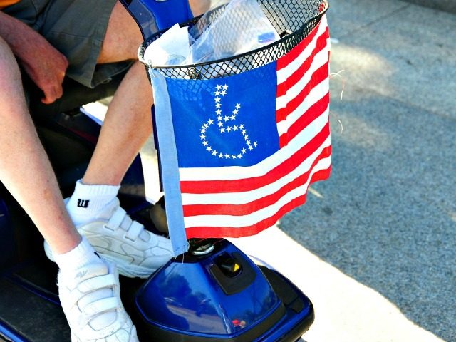 A member of ADAPT, a disability rights group, passes the White House during a protest April 27, 2009 in Washington, DC. The group is calling on US President Barack Obama to pass the Community Choice Act, a community-based alternative to nursing homes and institutions for people with disabilities AFP PHOTO/Karen …