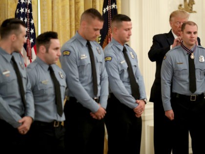 U.S. President Donald Trump presents the Medal of Valor to Officer Brian Rolfes of the Dayton Police Department during a White House ceremony September 9, 2019 in Washington, DC. Rolfes was presented with the honor along with Officer Jeremy Campbell, Sgt. William Knight , Officer Vincent Carter, Officer Ryan Nabel …