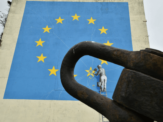 A mural by British artist Banksy, depicting a workman chipping away at one of the stars on a European Union (EU) themed flag, is pictured in Dover, south east England on January 7, 2019. - Britain's battle over Brexit resumes Monday when parliament returns from its Christmas break to debate …