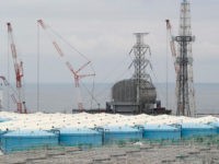 This picture taken on July 27, 2018 and made available on July 30, 2018 shows reactor unit 3 over storage tanks of radiation-contaminated water at the tsunami-crippled Tokyo Electric Power Company (TEPCO) Fukushima Dai-ichi nuclear power plant in Okuma, Fukushima prefecture. - The Fukushima nuclear disaster was triggered by a …