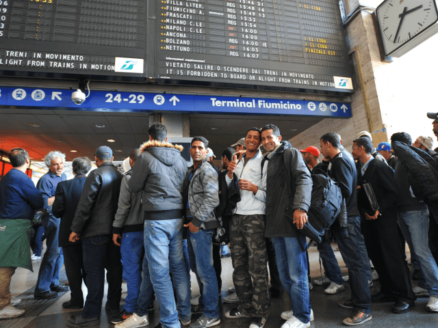 Tunisian would-be immigrants pose before boarding a train at Rome's Termini station to Ventimiglia, the Italian border town with France on April 21, 2011. Dozens out of the thousands who have fled from Tunisia to Italy by boat in recent weeks in the wake of the Jasmine Revolution in January …