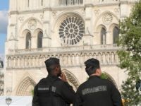 French gendarmes stand alert outside Notre-Dame de Paris Cathedral in Paris on April 29, 2019, two weeks after a fire ravaged the roof of the 850-year-old landmark. - Nearly two weeks later, a police cordon is still keeping members of the public well away from the site in the centre …