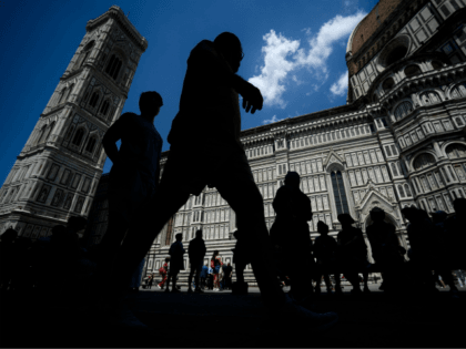 People walk outside the Santa Maria del Fiore Cathedral on June 18, 2019 in Florence. (Pho