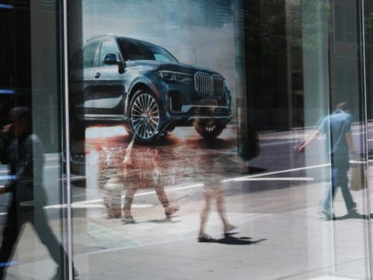 NEW YORK, NEW YORK - JUNE 11: People walk by a car dealership in Manhattan on June 11, 2019 in New York City. Disrupted by technology, a young generation indifferent to auto ownership, car hailing services and a resurgence in urban cycling, global auto sales are slipping for the first …