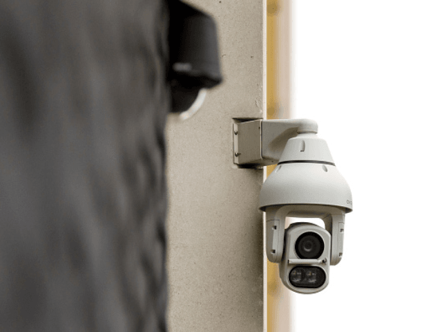 An Avigilon CCTV camera is seen on a wall in King's Cross, London on August 16, 2019. - Th