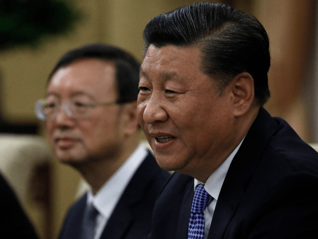 Chinese President Xi Jinping (R) speaks to Philippine President Rodrigo Duterte (not pictu