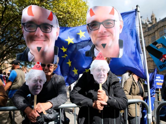 Anti-Brexit activists, and demonstrators opposing the British government's actions in relation to the handling of Brexit, protest holding placards showing the faces of Britain's Prime Minister Boris Johnson and his chief adviser Dominic Cummings outside the Houses of Parliament in central London on September 4, 2019. - British Prime Minister â¦