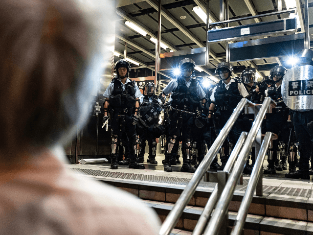 Police officers stand guard at Po Lam Station during a standoff with protesters on Septemb