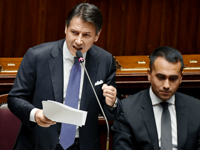 Italy's Prime Minister Giuseppe Conte (L) delivers a speech as Italy's Foreign M