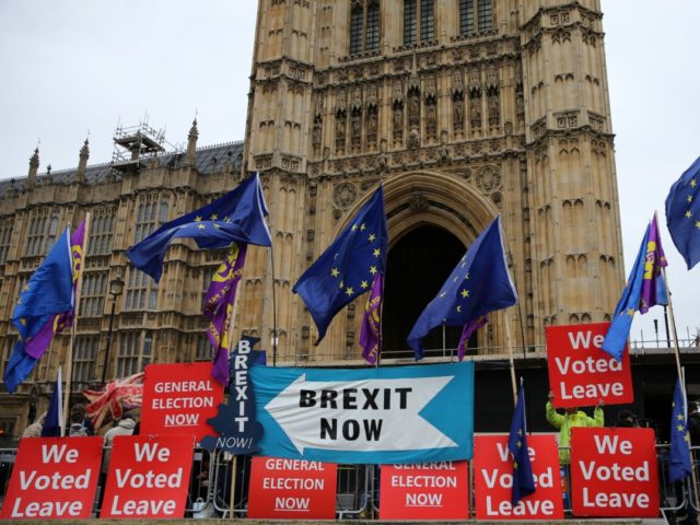 Pro-Brexit protesters stand with "We Voted Leave" placards among signs calling for "Brexit Now" and EU flags outside the Houses of Parliament in London on September 9, 2019. - British Prime Minister Boris Johnson met his Irish counterpart in Dublin on Monday as he battles to salvage his hardline Brexit …