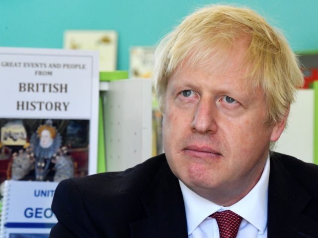 Britain's Prime Minister Boris Johnson speaks with year four and year six pupils duri