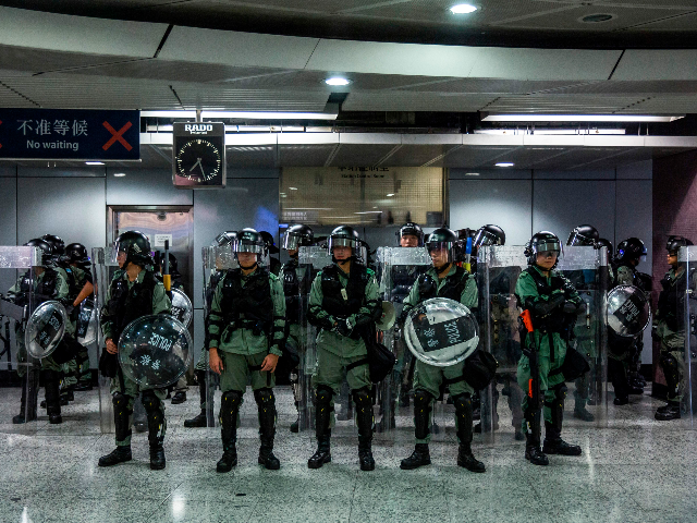 Riot police stand guard inside a train station in the Causeway Bay district of Hong Kong o