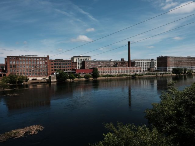 LAWRENCE, MASSACHUSETTS - AUGUST 16: Old factories sit along the river in Lawrence on August 16, 2019 in Lawrence, Massachusetts. Lawrence, once one of America’s great manufacturing cities with immigrants from around the world coming to work in its textile and wool processing mills, has struggled to find its economic …