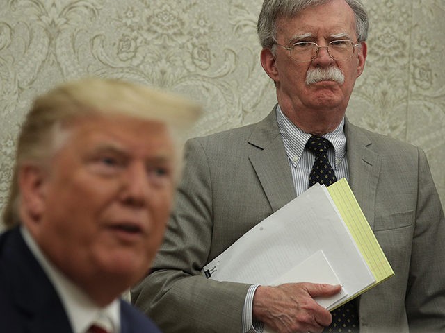 WASHINGTON, DC - AUGUST 20: U.S. President Donald Trump speaks to members of the media as National Security Adviser John Bolton listens during a meeting with President of Romania Klaus Iohannis in the Oval Office of the White House August 20, 2019 in Washington, DC. This is Iohannis’ second visit …