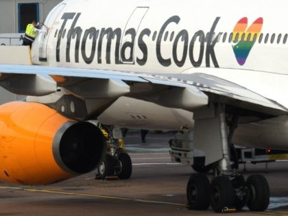 A worker closes the door of a Thomas Cook passenger aircraft after it landed at Manchester