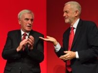 Britain's main opposition Labour Party Leader Jeremy Corbyn (R) gestures to Labour party's shadow Chancellor John McDonnell (L) on stage after McDonnell's speech during the Labour party conference in Brighton, on the south coast of England on September 23, 2019. - Britain's main opposition Labour Party was set Monday to …