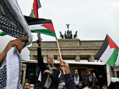 People wave Palestian flags at the Brandenburg Gate during a pro-Palestinian rally in Berlin on September 25, 2019. - Berlin authorities barred a planned appearance by two rappers during a pro-Palestinian rally at the Brandenburg Gate on the grounds of "anti-Semitic messages" in their lyrics. (Photo by Tobias SCHWARZ / …
